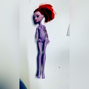 Monster high doll with design on face and tattoo arm
